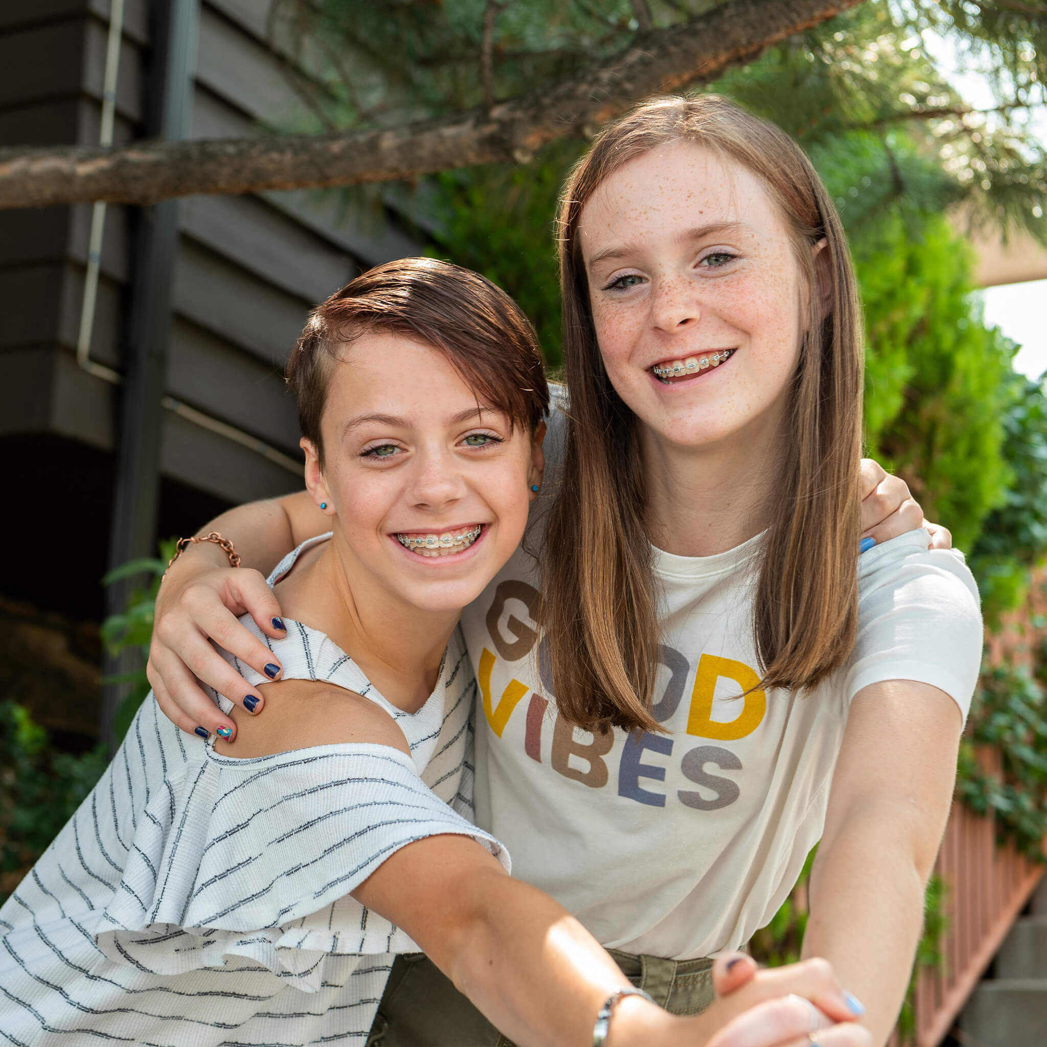 smiling young teens with braces