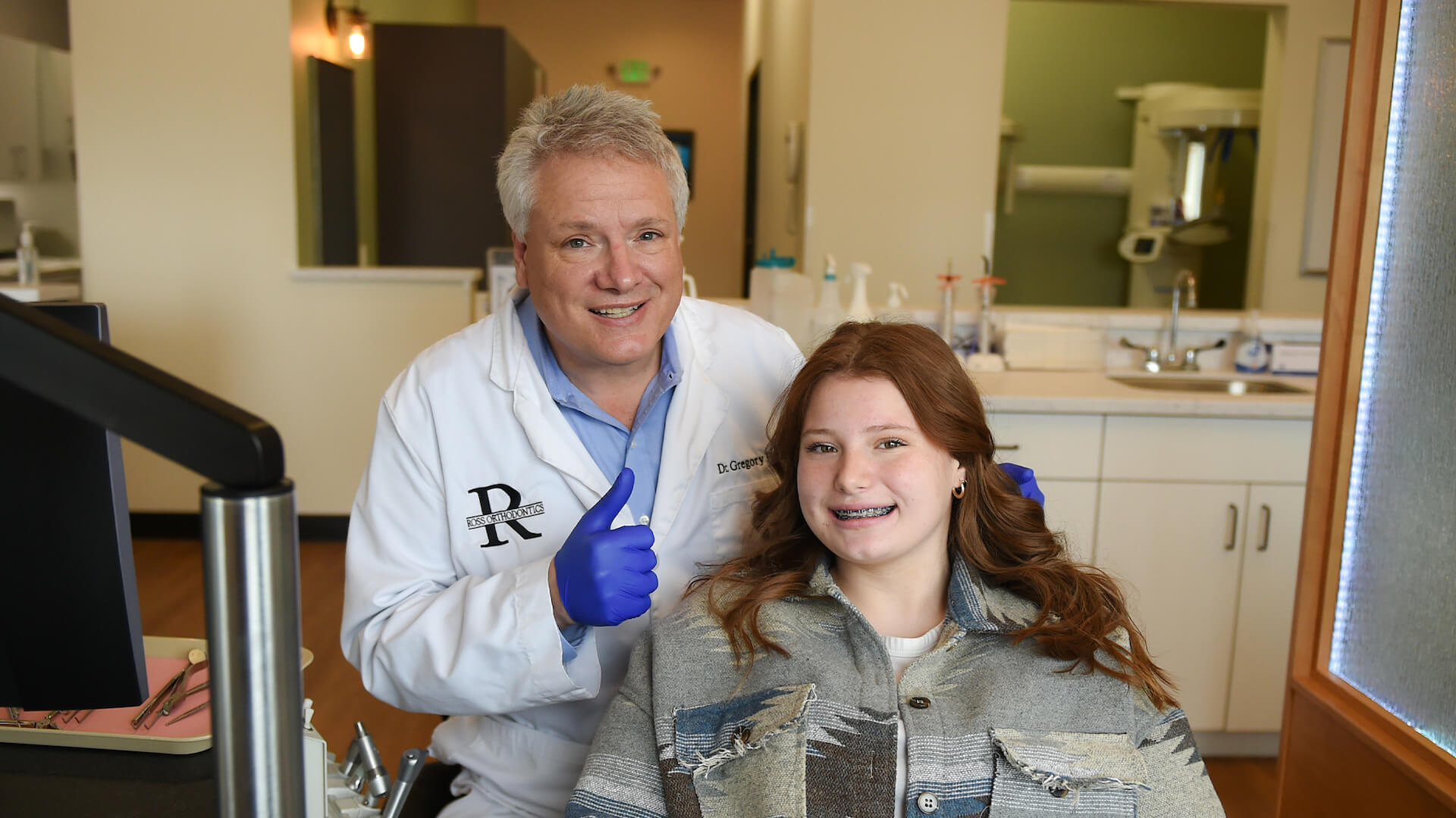 dr. ross with patient smiling