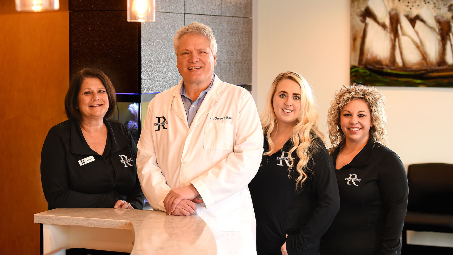 dr. ross with patients smiling